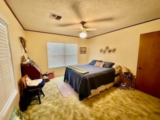 bedroom featuring a textured ceiling, carpet, ceiling fan, and multiple windows