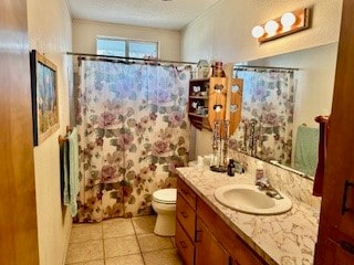 bathroom with a shower with shower curtain, tile patterned floors, vanity, and toilet