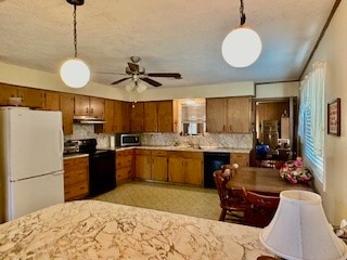 kitchen with hanging light fixtures, black appliances, ceiling fan, and tasteful backsplash