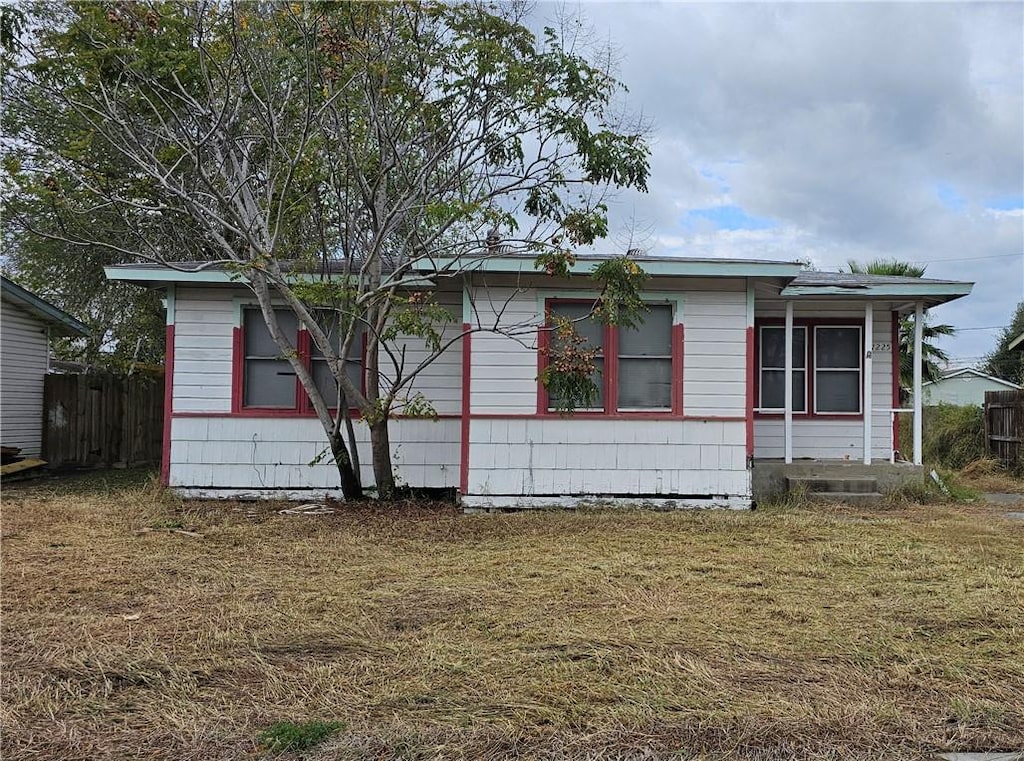 view of side of home with a lawn