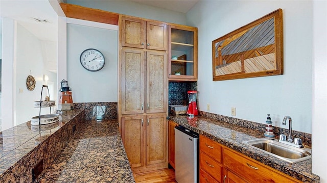 kitchen featuring fridge and sink