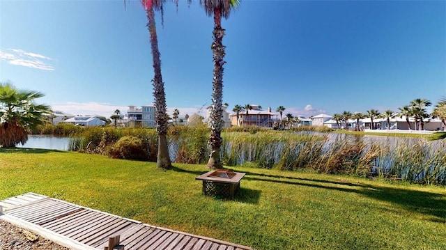 view of yard featuring an outdoor fire pit and a water view