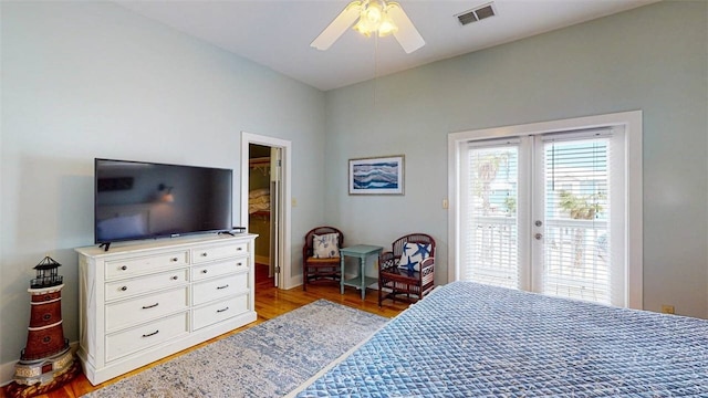 bedroom featuring ceiling fan, access to exterior, light hardwood / wood-style floors, and french doors