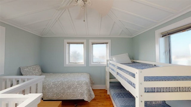 bedroom with wood-type flooring and vaulted ceiling