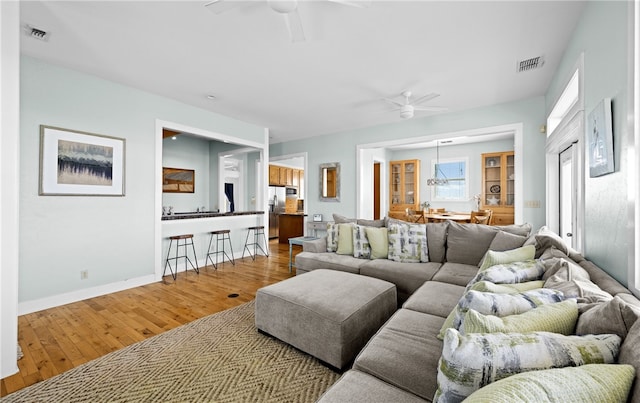 living room featuring hardwood / wood-style floors and ceiling fan