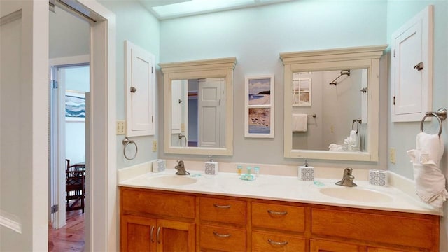 bathroom with vanity and a skylight