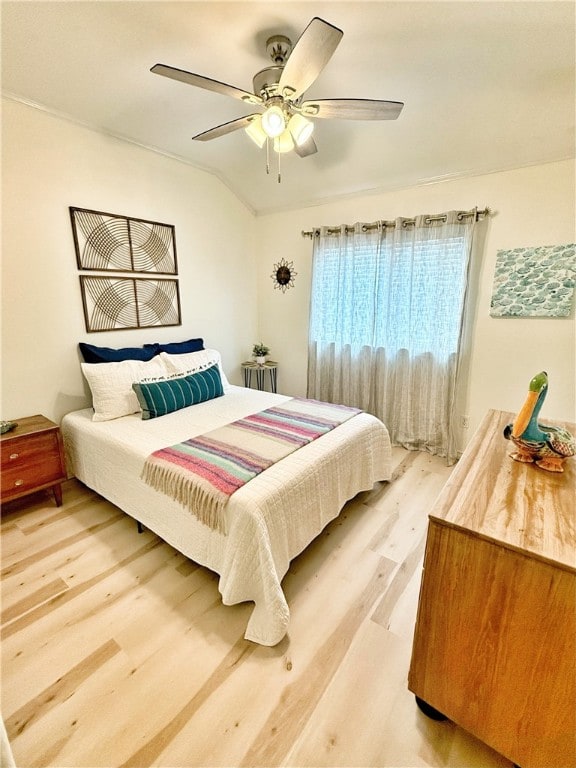 bedroom with hardwood / wood-style flooring, ceiling fan, and lofted ceiling