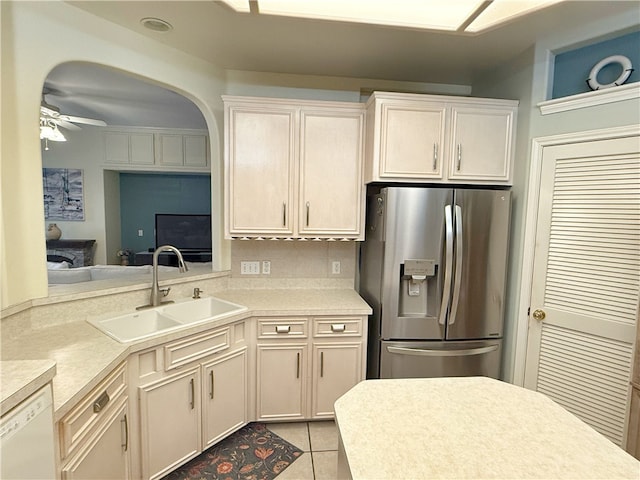 kitchen with dishwasher, sink, stainless steel refrigerator with ice dispenser, ceiling fan, and light tile patterned floors