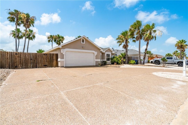 14825 Dasmarinas Dr, Corpus Christi, TX 78418 - view of front facade featuring stucco siding, an attached garage, and concrete driveway