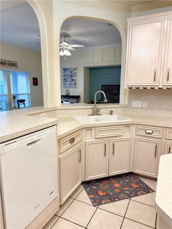 kitchen featuring white dishwasher, sink, ceiling fan, light tile patterned floors, and ornamental molding