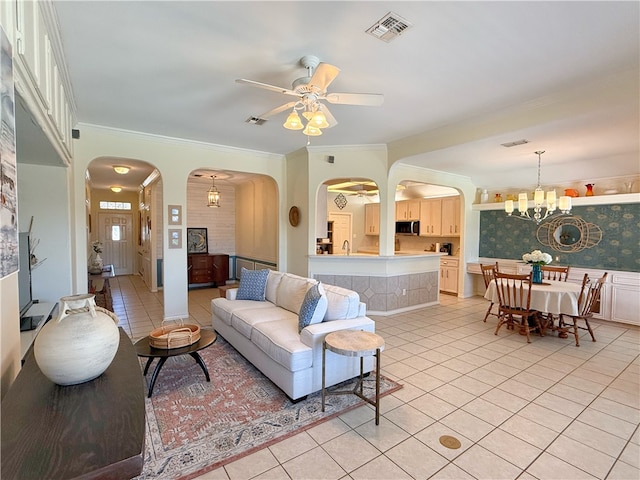 living room with ceiling fan with notable chandelier, ornamental molding, sink, and light tile patterned floors