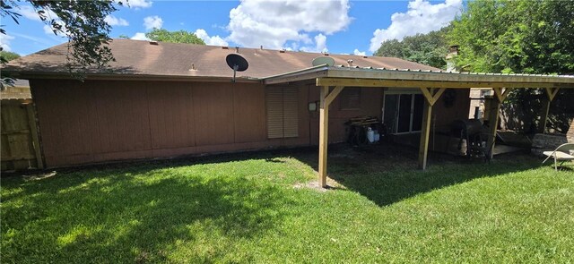 9334 Moon Beam, Corpus Christi, TX 78409 - rear view of house with a lawn and a carport