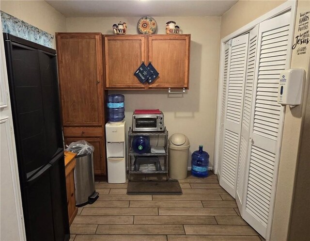 9334 Moon Beam, Corpus Christi, TX 78409 - kitchen with light wood finished floors and brown cabinetry