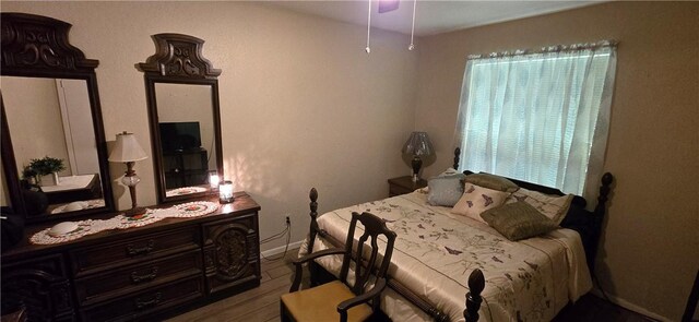 9334 Moon Beam, Corpus Christi, TX 78409 - bedroom featuring baseboards, multiple windows, and wood finished floors
