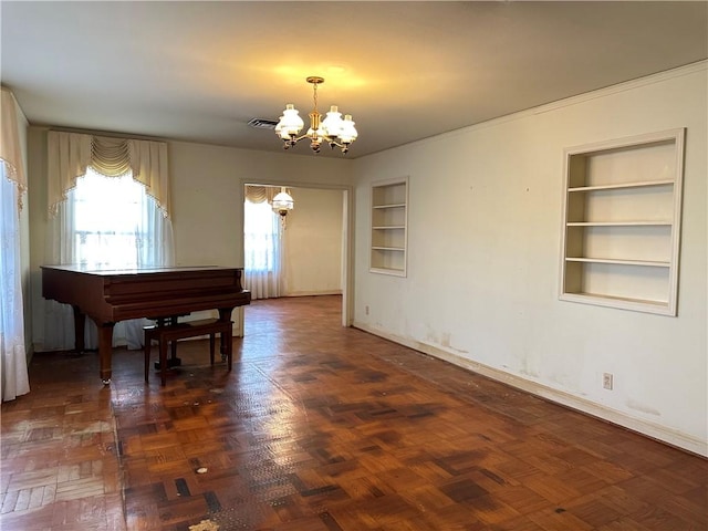 miscellaneous room with an inviting chandelier, built in features, and dark parquet floors