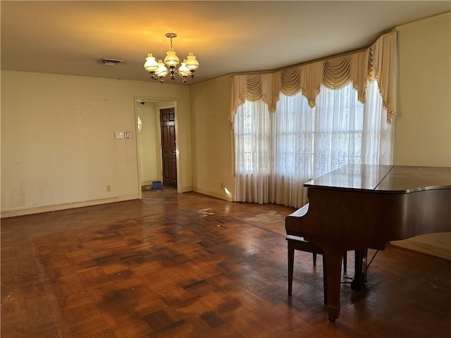 miscellaneous room with dark parquet flooring and an inviting chandelier