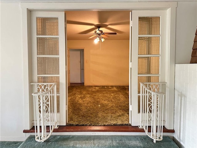 view of exterior entry with ceiling fan