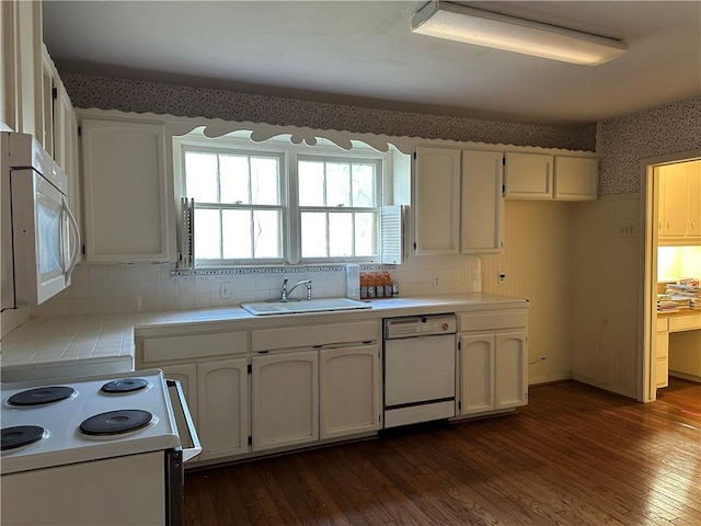 3102 Topeka St, Corpus Christi, TX 78404 - kitchen with white appliances, wallpapered walls, tile counters, white cabinetry, and dark wood-type flooring