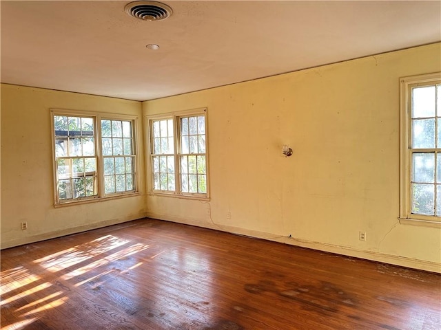 unfurnished room with hardwood / wood-style floors