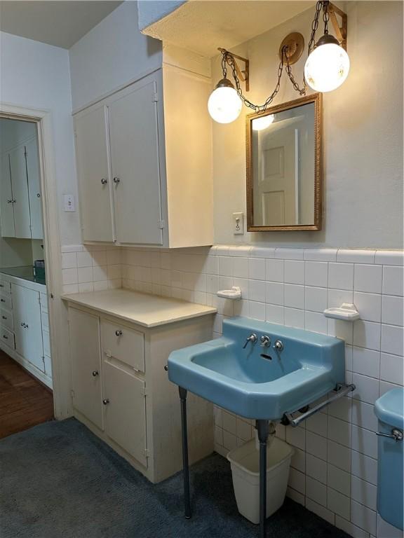 3102 Topeka St, Corpus Christi, TX 78404 - bathroom with tile walls and a wainscoted wall