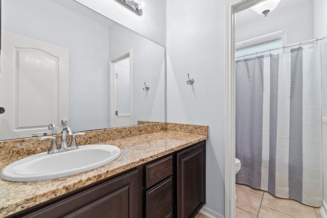bathroom featuring vanity, tile patterned flooring, toilet, and curtained shower