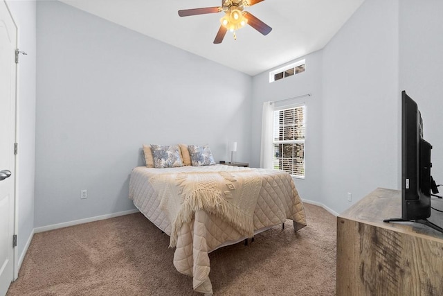 carpeted bedroom featuring baseboards and ceiling fan