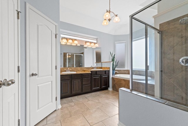 bathroom featuring a sink, a garden tub, a stall shower, and double vanity