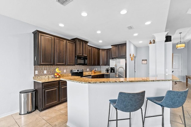 kitchen with backsplash, stainless steel appliances, light stone countertops, and visible vents