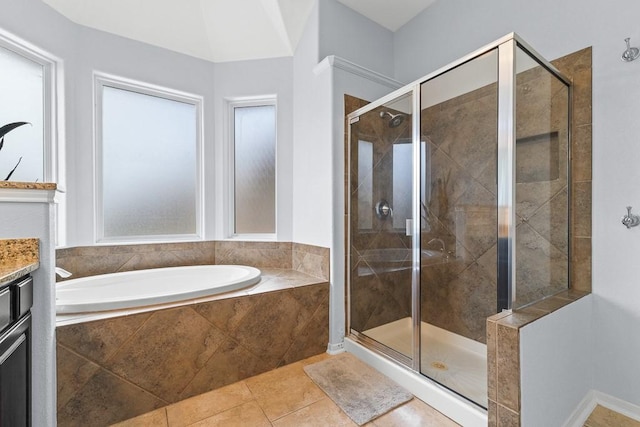 bathroom with vanity, tile patterned floors, a bath, and a shower stall