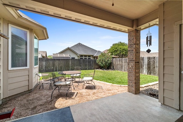 view of patio with outdoor dining space and a fenced backyard