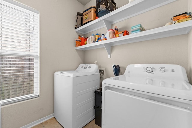 laundry area with laundry area, independent washer and dryer, and light tile patterned floors