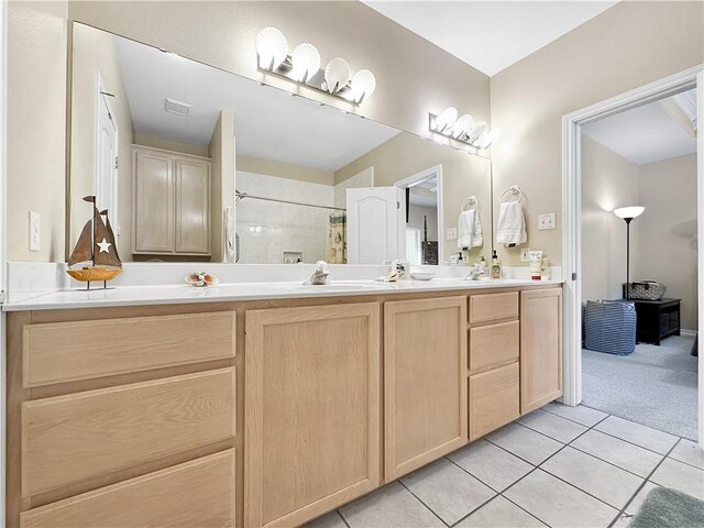 bathroom featuring a sink, curtained shower, and tile patterned flooring