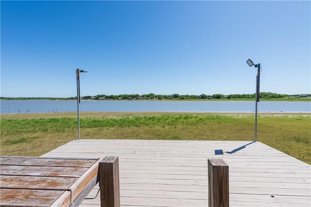 132 Zenna Dr, Mathis, TX 78368 - dock area featuring a deck with water view and a lawn