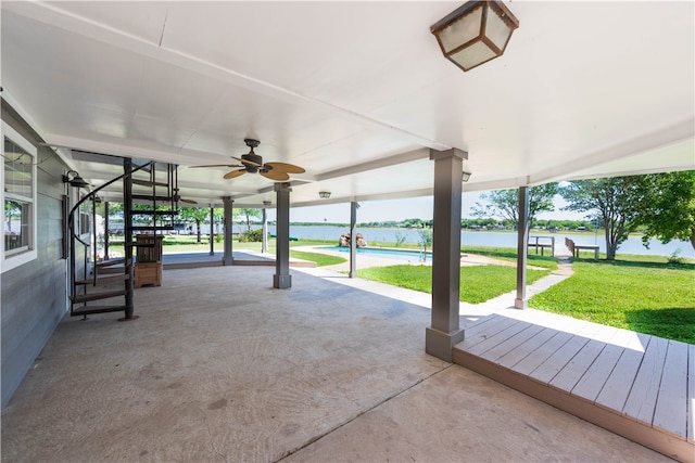 view of patio / terrace featuring a water view and ceiling fan