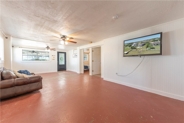 living room featuring concrete flooring, a textured ceiling, and ceiling fan