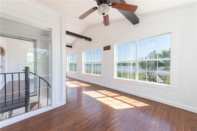 unfurnished room with dark hardwood / wood-style flooring, ceiling fan, a healthy amount of sunlight, and lofted ceiling with beams