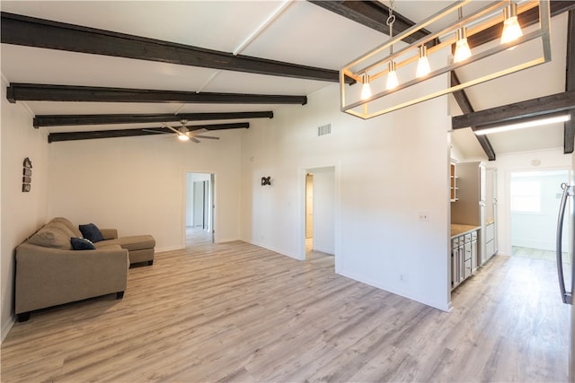 living room featuring lofted ceiling with beams, light hardwood / wood-style flooring, and ceiling fan