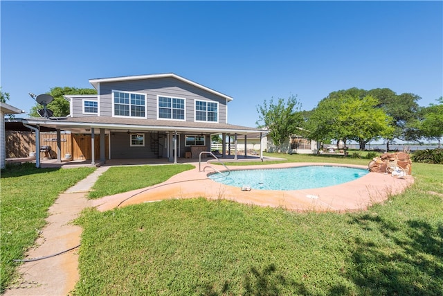 back of house with a patio and a yard