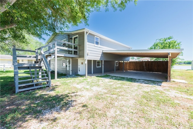 back of house with a yard and a carport