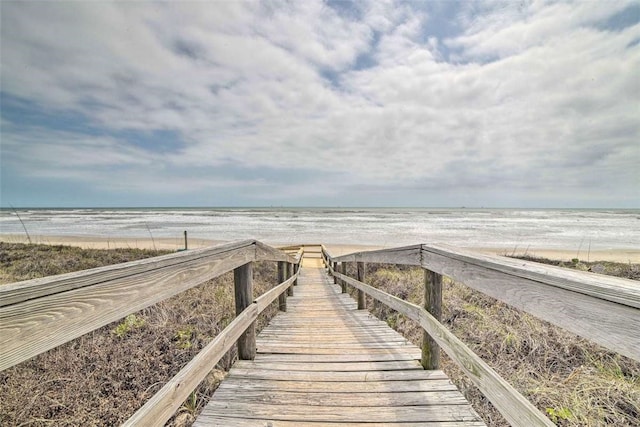 view of property's community featuring a beach view and a water view