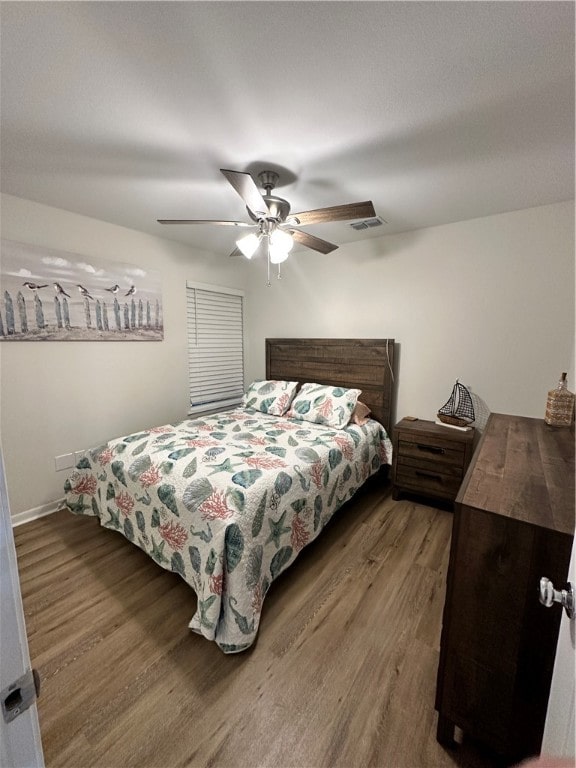 bedroom with hardwood / wood-style floors and ceiling fan