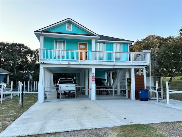 beach home featuring a carport and covered porch