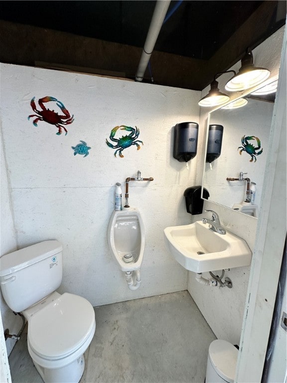 bathroom with toilet, concrete flooring, and sink