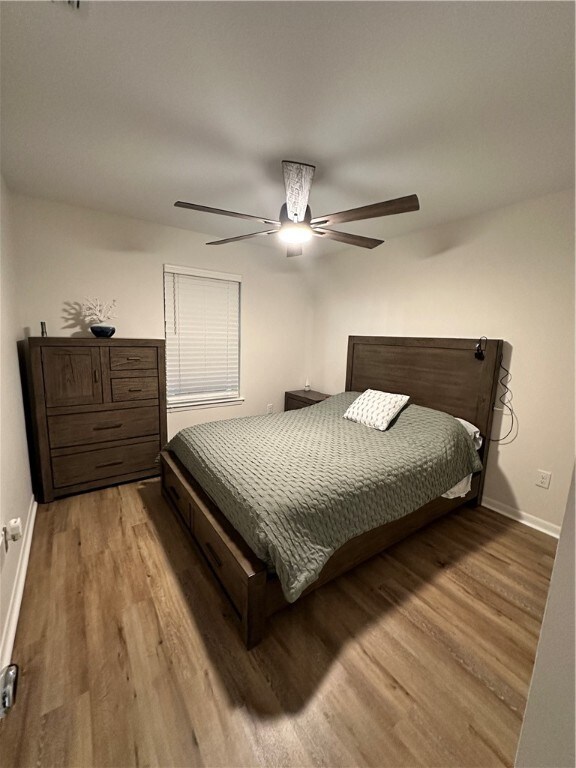 bedroom featuring wood-type flooring and ceiling fan