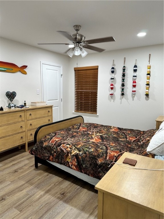 bedroom with hardwood / wood-style flooring and ceiling fan