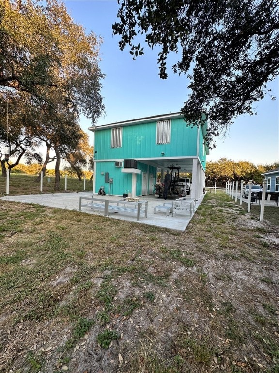 back of house with a lawn