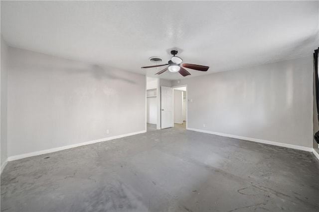 unfurnished room featuring visible vents, baseboards, unfinished concrete flooring, and a ceiling fan
