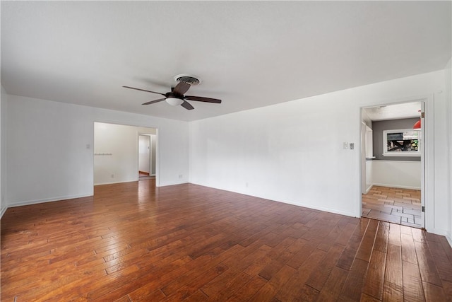 spare room featuring ceiling fan and dark wood-type flooring