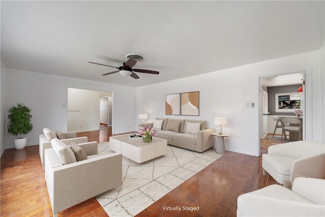 living room with ceiling fan and light wood-type flooring