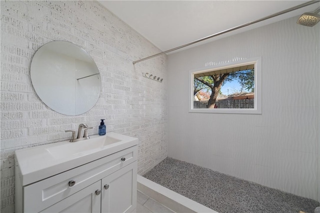 bathroom featuring a shower, tile patterned floors, and vanity